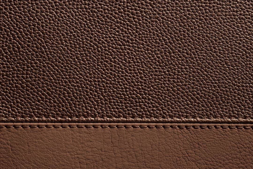 Brown leather with stitching, creating a textural look.