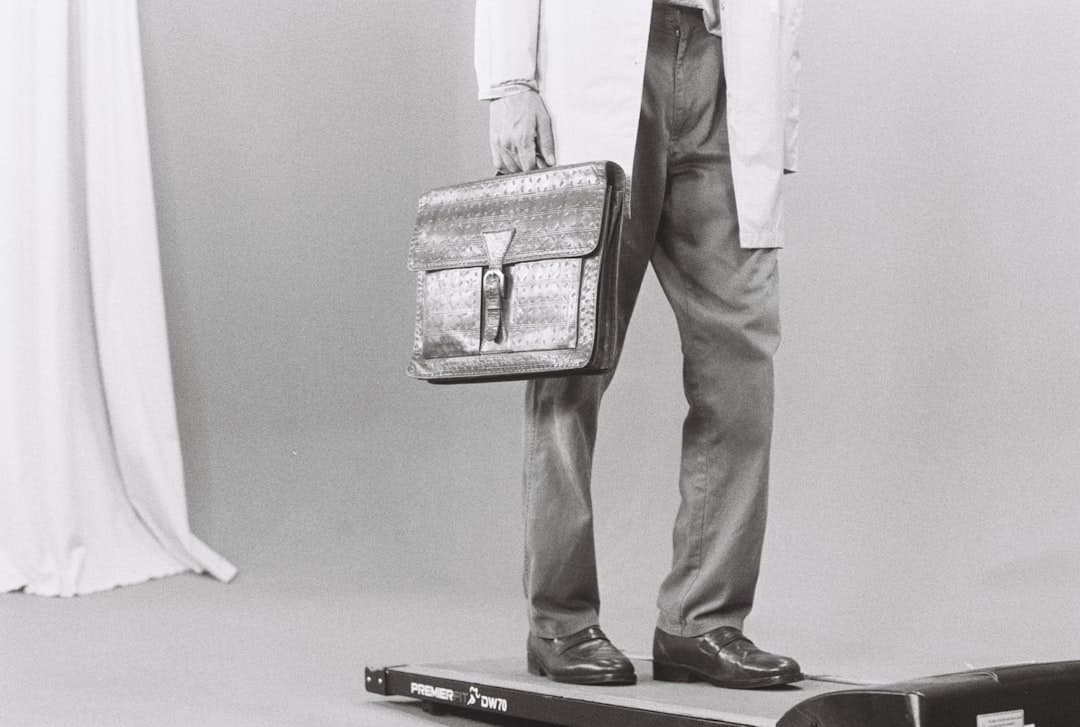 Man in lab coat holding briefcase on scale